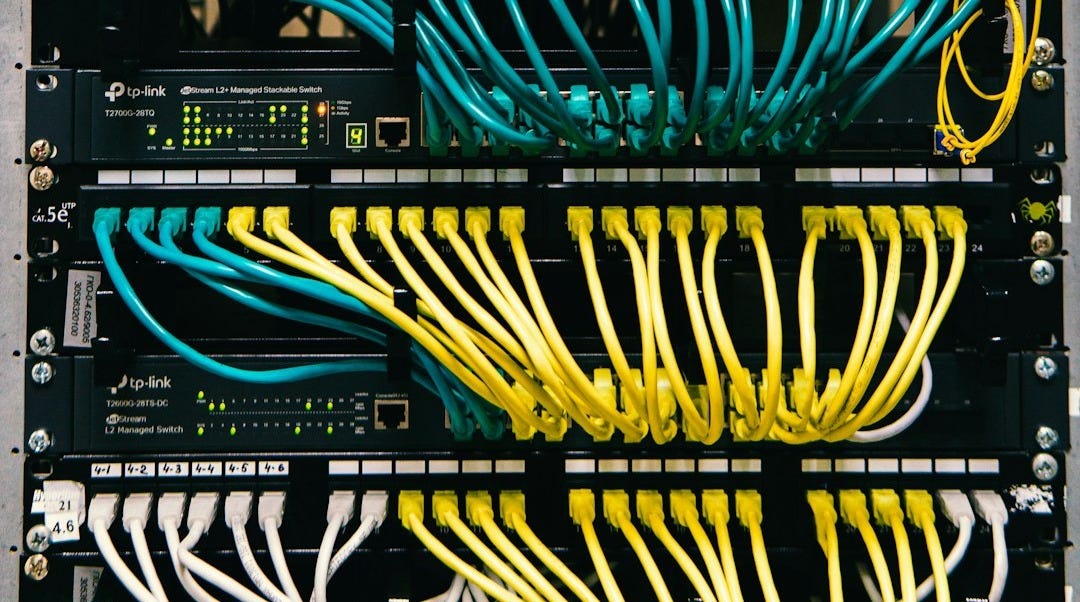 a rack of servers with wires and wires attached to them a rack of servers with wires and wires attached to them
