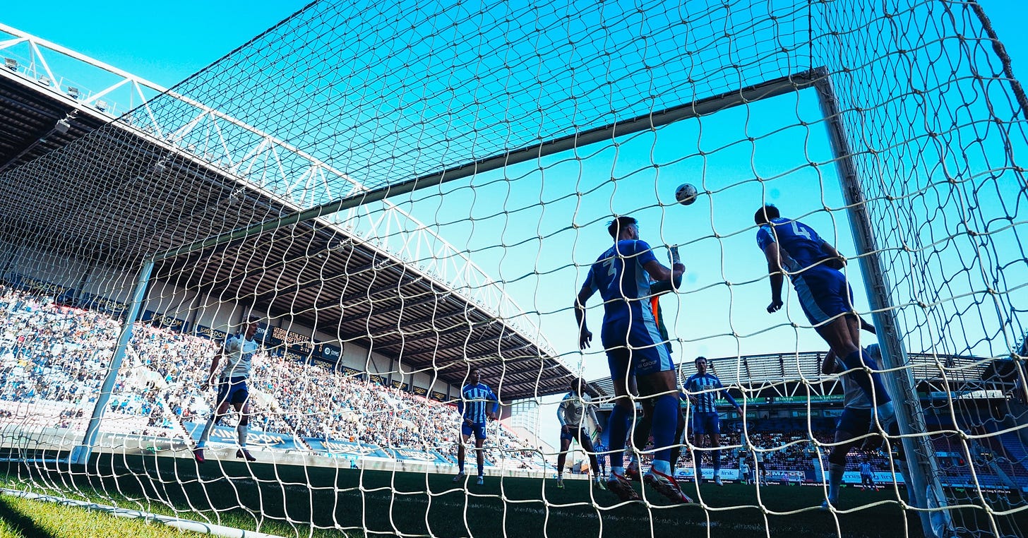 Wigan defenders clear the ball off the line after a Huddersfield Town attack. Wigan defenders clear the ball off the line after a Huddersfield Town attack.