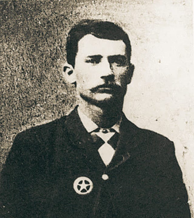 Photo of Brown with badge.