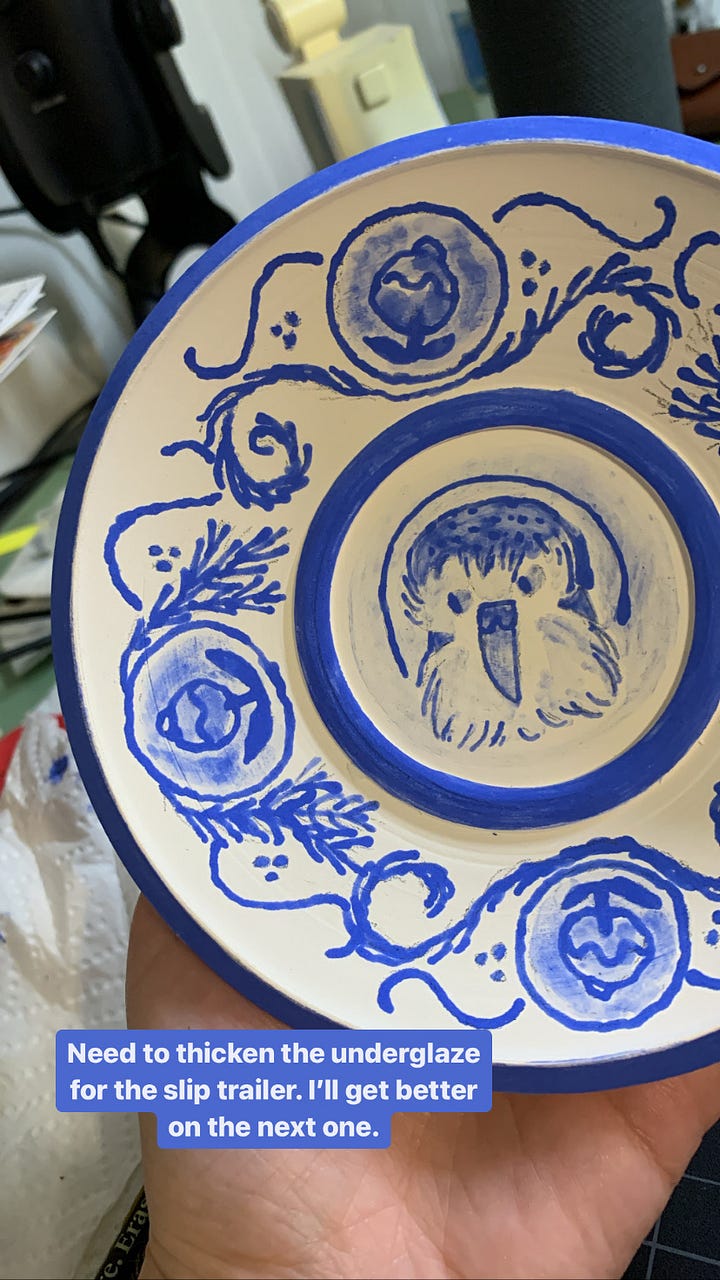 ceramic mugs and a saucer in different phases of the illustration process using underglaze and a slip trailer by Kayla Stark