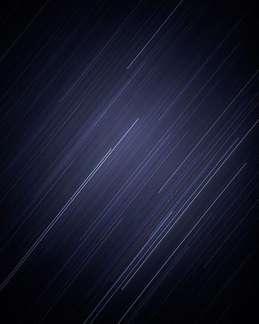 A picture of light streaks across a dark sky.