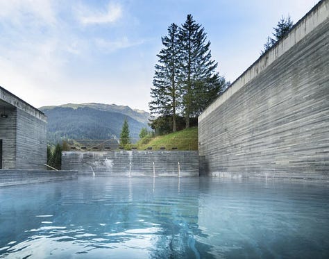 Interior of Therme Vals thermal baths by Peter Zumthor, Vals, Switzerland. Dark quartzite stone walls and thermal water pools lit by natural light from above. Architecture by Peter Zumthor.