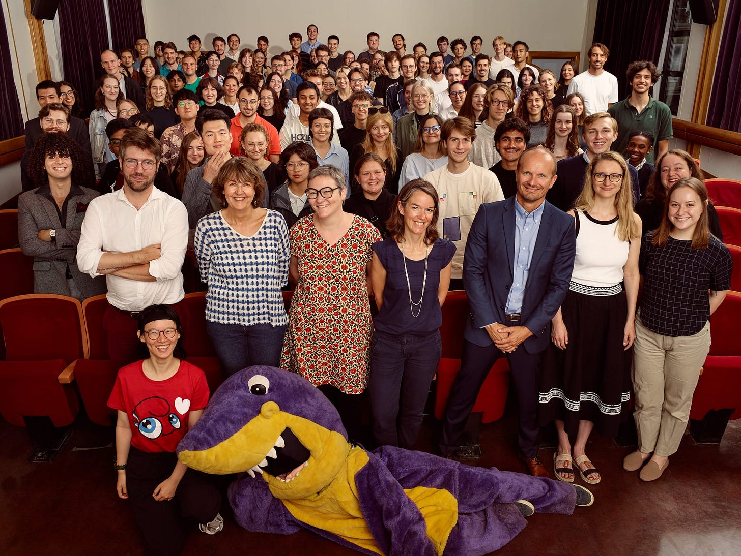 All the international students entering the ENS this year (plus the school's conspicuous mascot) pose for a photo in a lecture theatre
