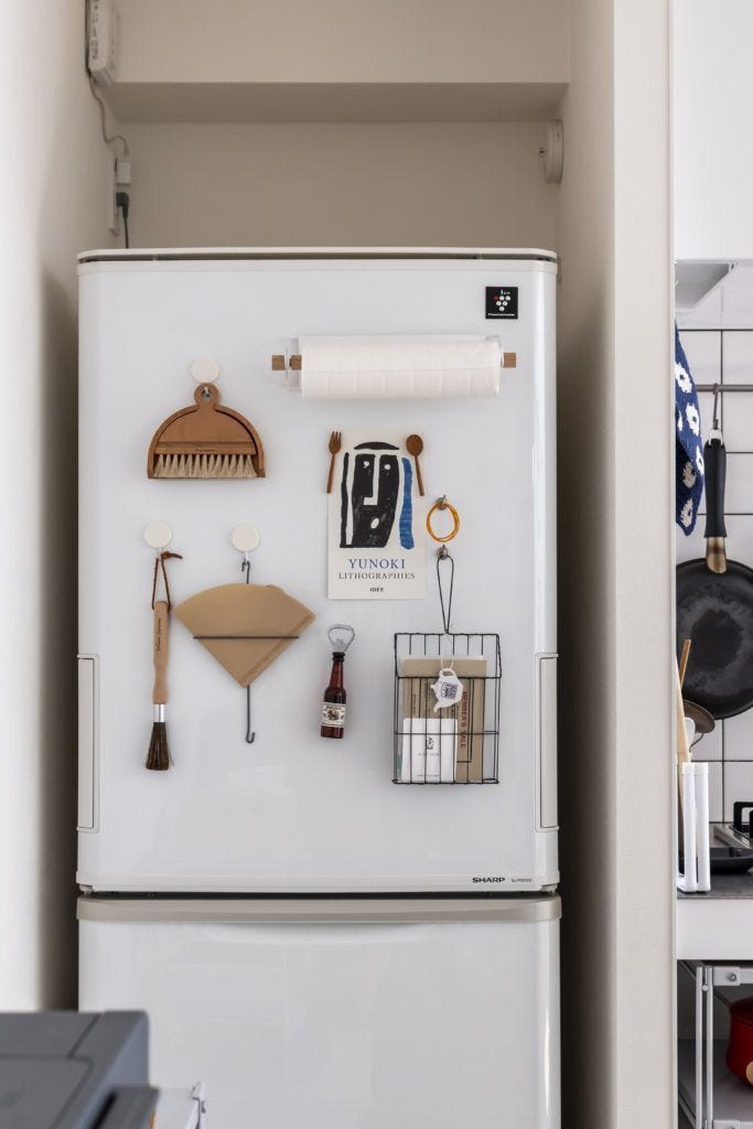 This may contain: a white refrigerator freezer sitting inside of a kitchen