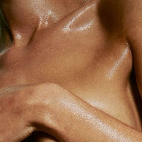 This may contain: a close up view of the back of a man's torso with no shirt on