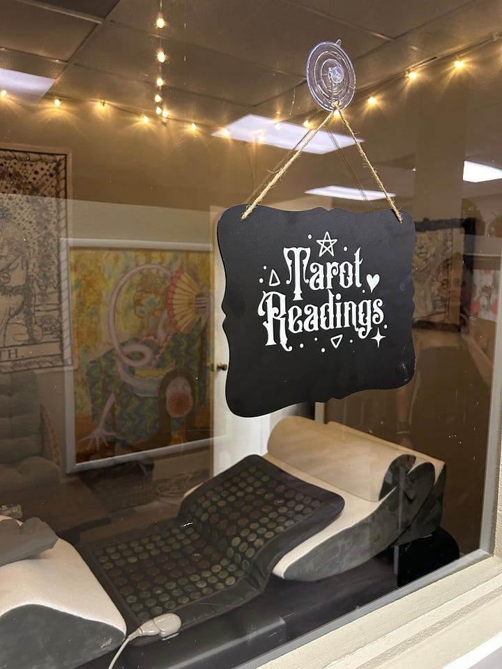 Collage of five images including a tattoo chair, women's clothing mannequin, display of earrings, greenery wall in a craft room, and small room with a sign that says "tarot".