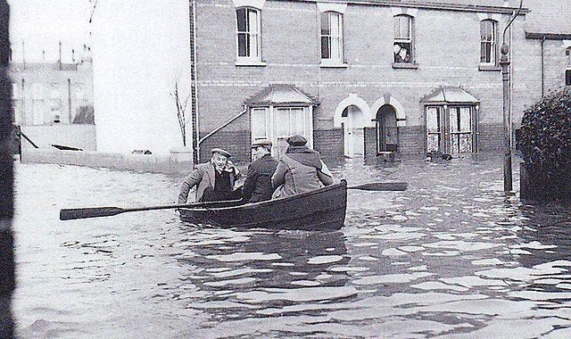 Photograph of men in a rowing boat following a rescue from the 1953 flood in Harwich