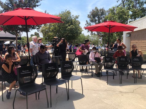 Ribbon Cutting, Chris Slama, and a mom and chld inside the library