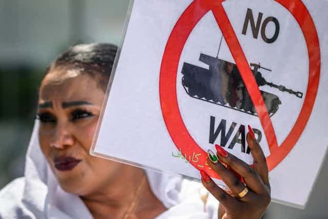 A woman holds an anti-war placard during a demonstration A woman holds an anti-war placard during a demonstration
