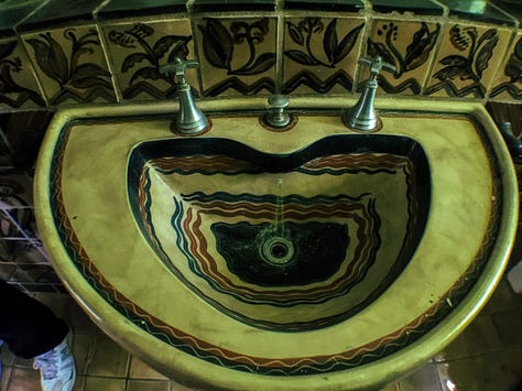 a ceramic toilet, sink, and shower