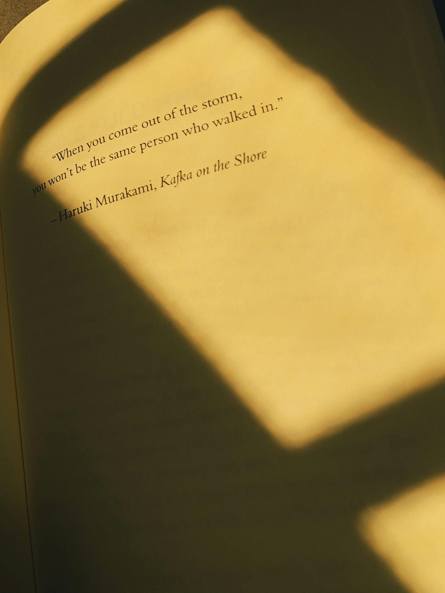 Free A book page with Haruki Murakami quote in soft shadow. Stock Photo