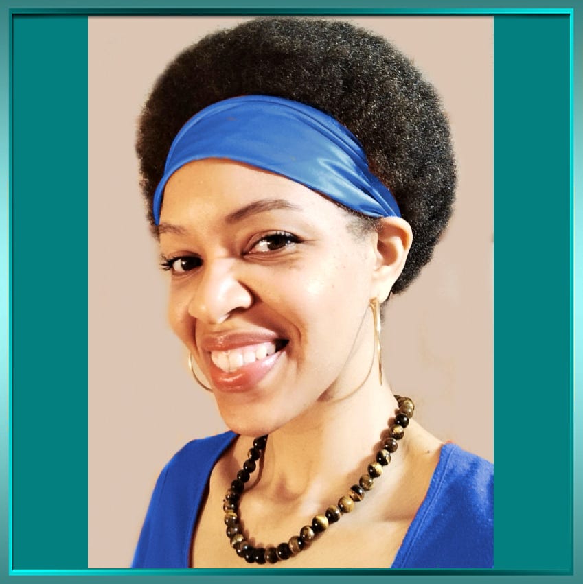 A smiling Black American woman with an Afro