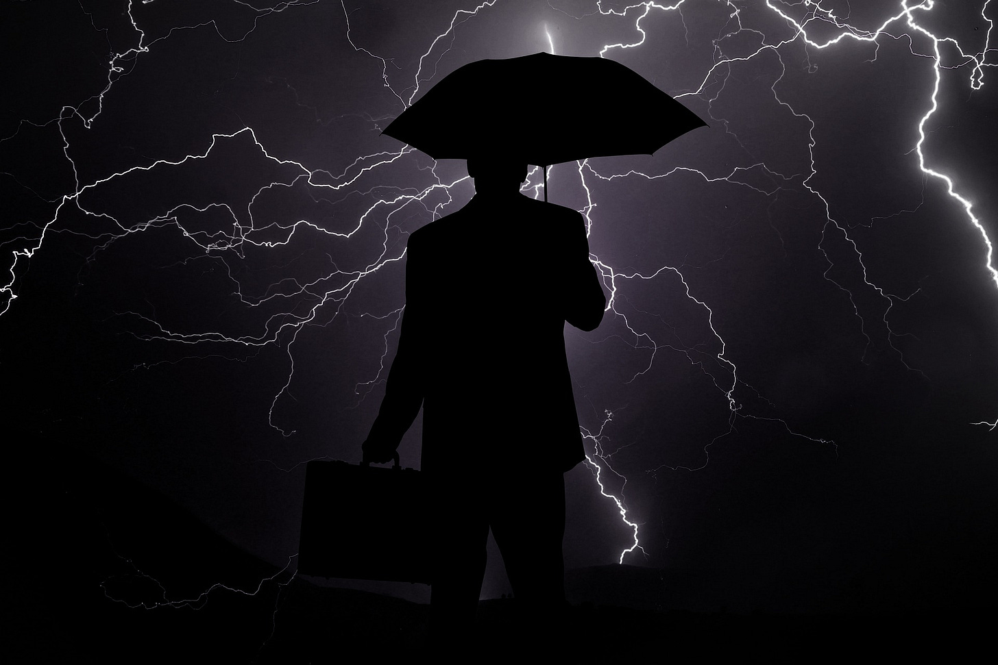 Picture of business man caught in a storm, holding an umbrella Picture of business man caught in a storm, holding an umbrella