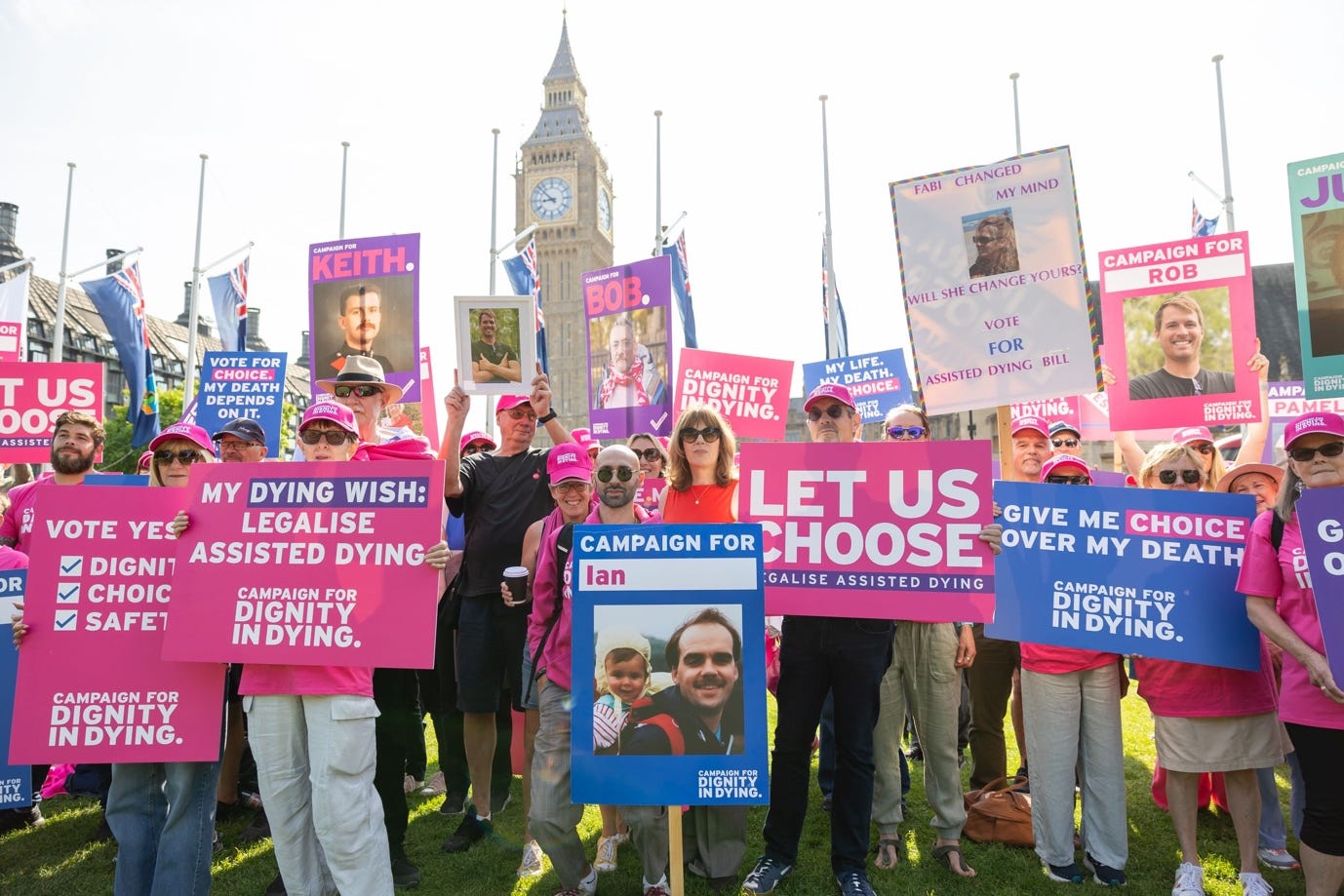 A group of people holding signs

Description automatically generated