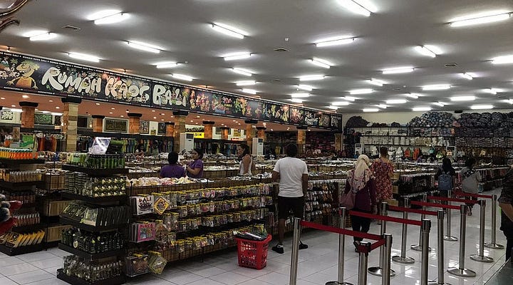 Top left: A Pasalubong store selling specialty products from Bicol; Top right: Various pasalubong items in a Filipino store; Bottom left: Oleh-oleh store in Bali; Bottom right: Oleh-oleh specialty products from Makassar