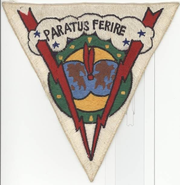 The image depicts a vintage-style emblem featuring a red circle with a shield and crossed sword, surrounded by a green and yellow motif, all encased in a white border.

AI-generated content may be incorrect.