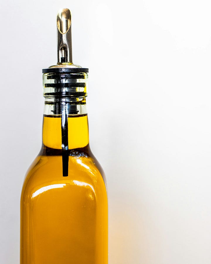 Zuchini. Bottlle of Olive oil. Photos by By Pils and Jonathan Ocampo via Unsplash.
