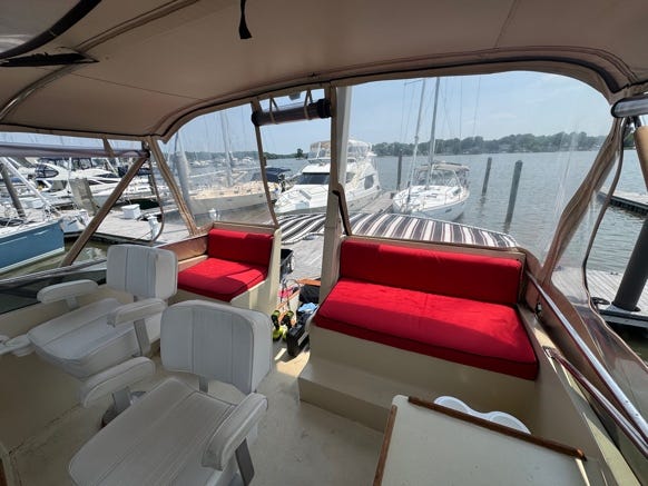 A boat with a view of the water and boats

Description automatically generated