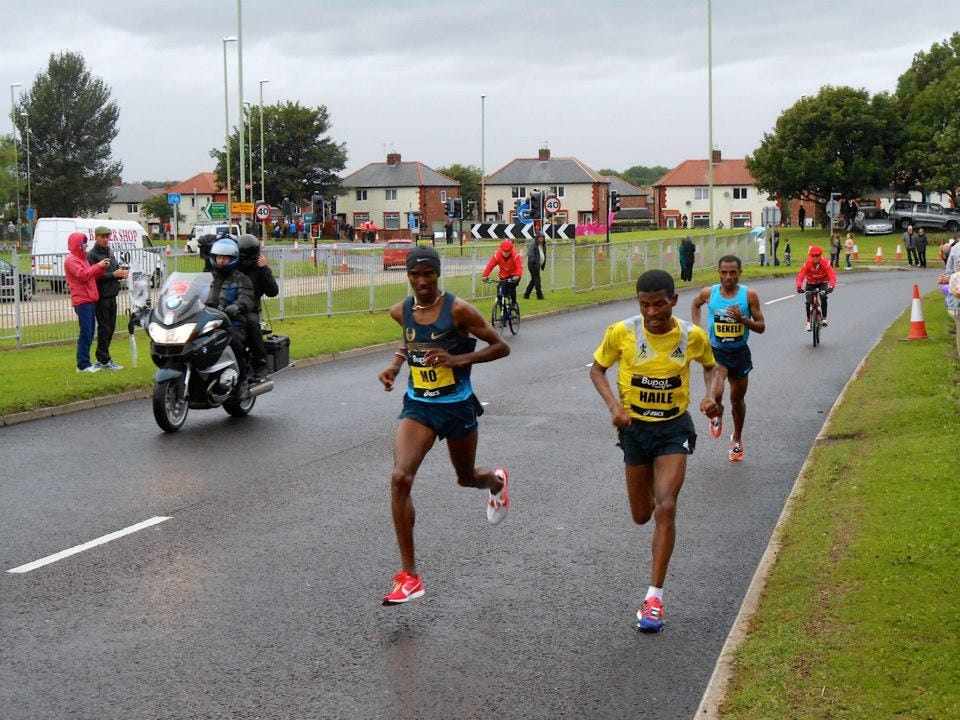 Mo Farah, Haile Gebrselassie, and eventual winner Kenenisa Bekele sprint past my mum at mile 8