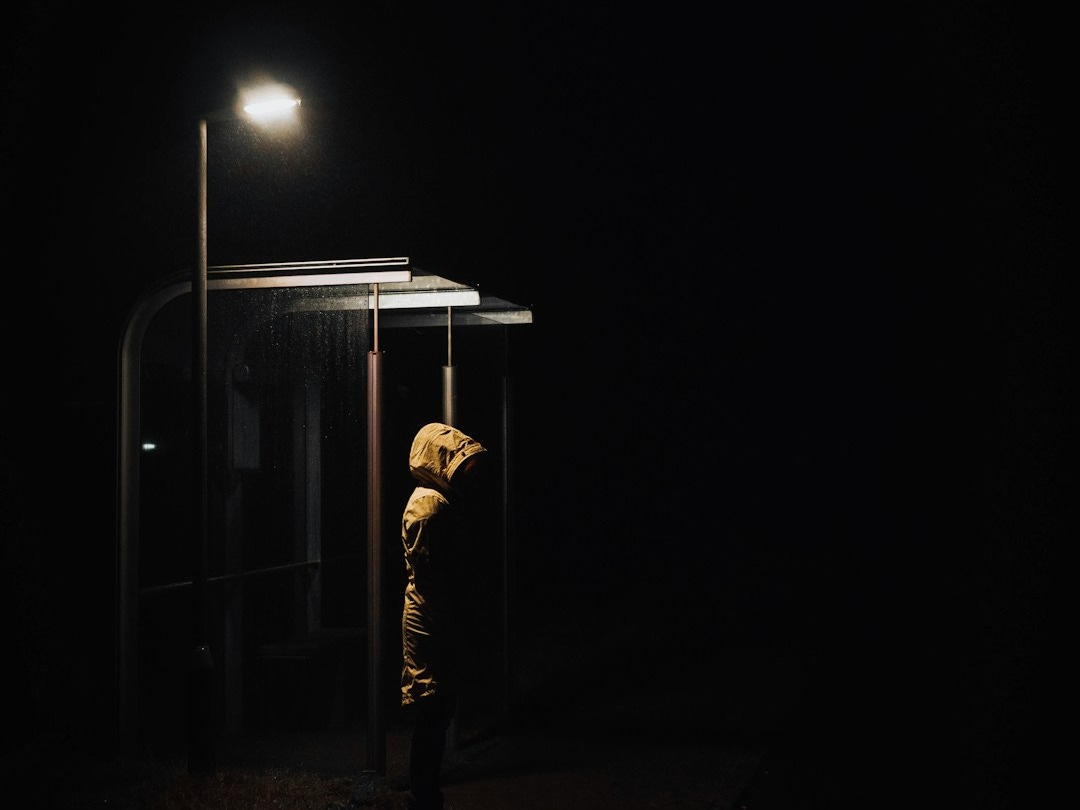 a person standing in the dark at night a person standing in the dark at night