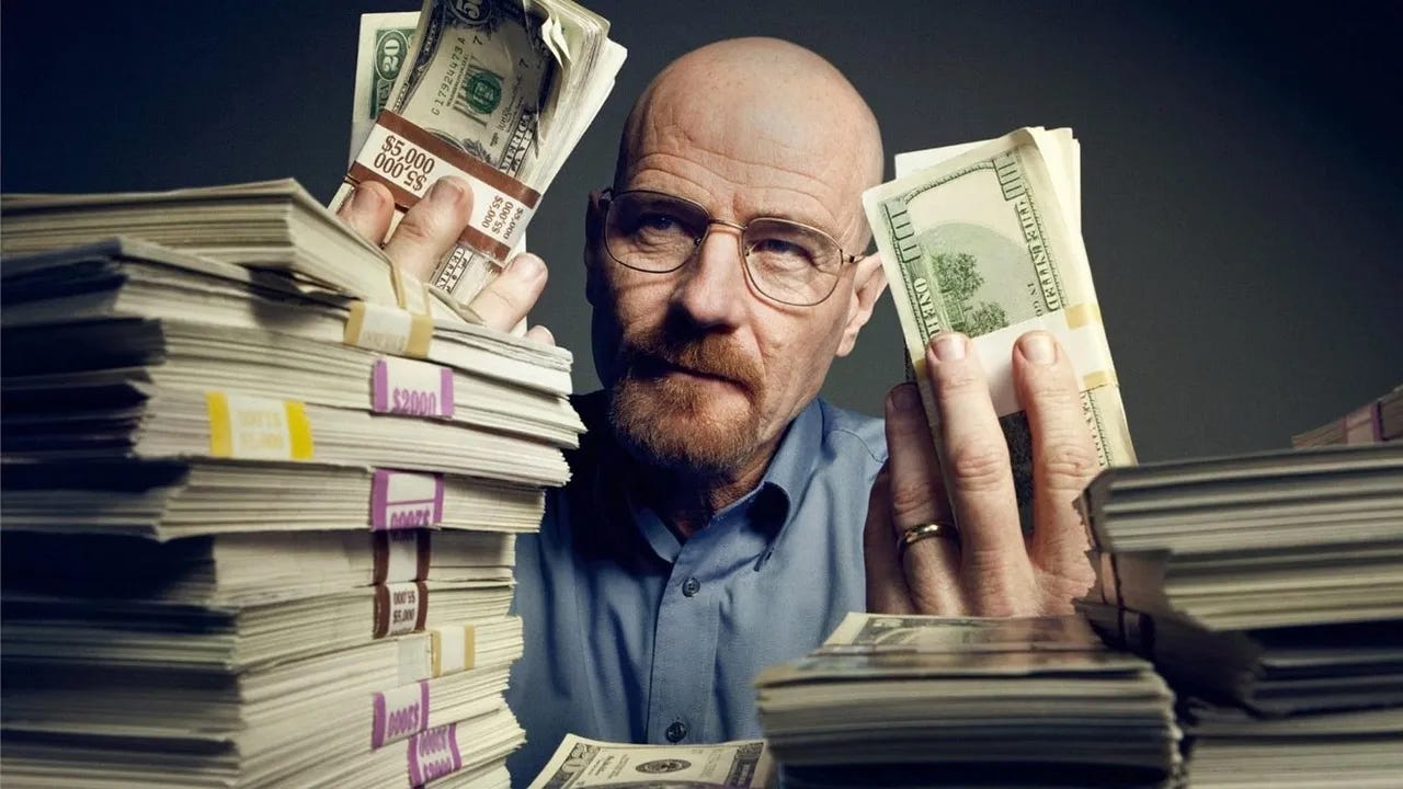 A bald man with glasses, resembling a serious character from a TV show, is holding large stacks of U.S. dollar bills in both hands. He is surrounded by towering piles of bundled cash on a table, creating a dramatic and intense atmosphere.