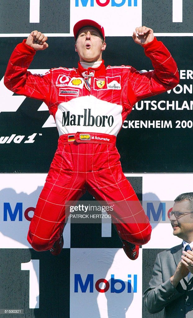German Ferrari driver Michael Schumacher jumps on the podium of the... News  Photo - Getty Images