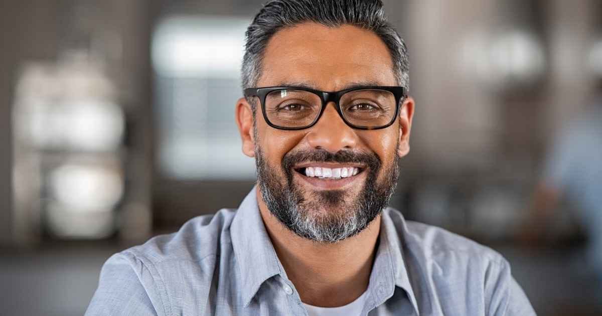 Man smiling looking at camera Man smiling looking at camera