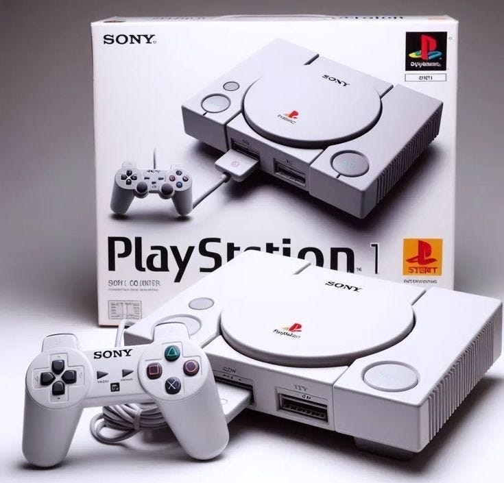 This may contain: an image of a video game system with two controllers in front of the box and another one behind it