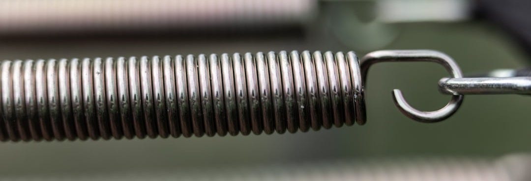 silver steel tube on white and green stripe textile