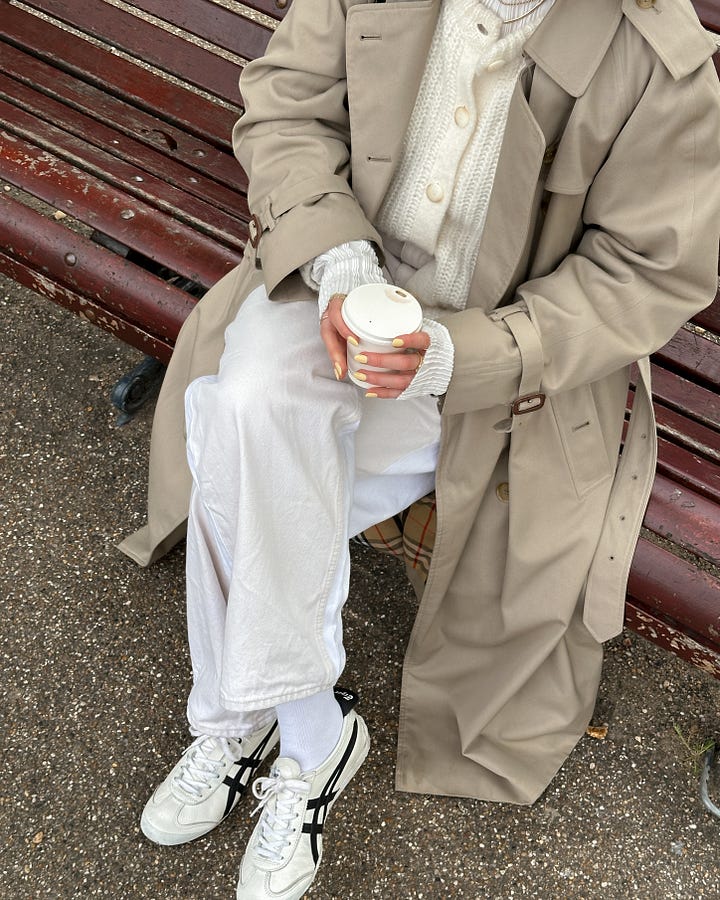 Lucy Moon wears beige onitsuka tiger sneakers, oversized vintage trench coat and suede bag.