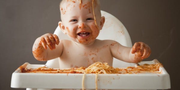 Baby covered in spaghetti