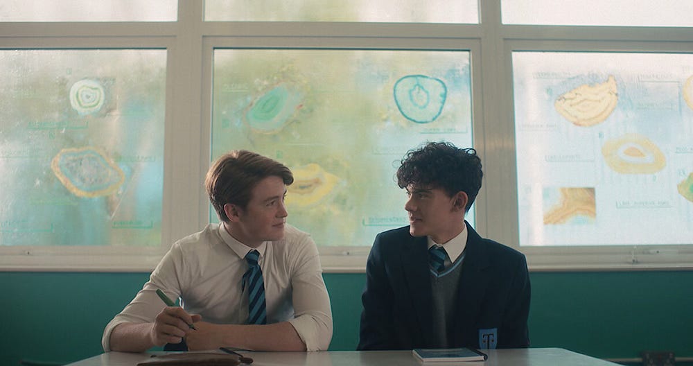 Nick and Charlie in Heartstopper, sititng at their school desk Nick and Charlie in Heartstopper, sititng at their school desk