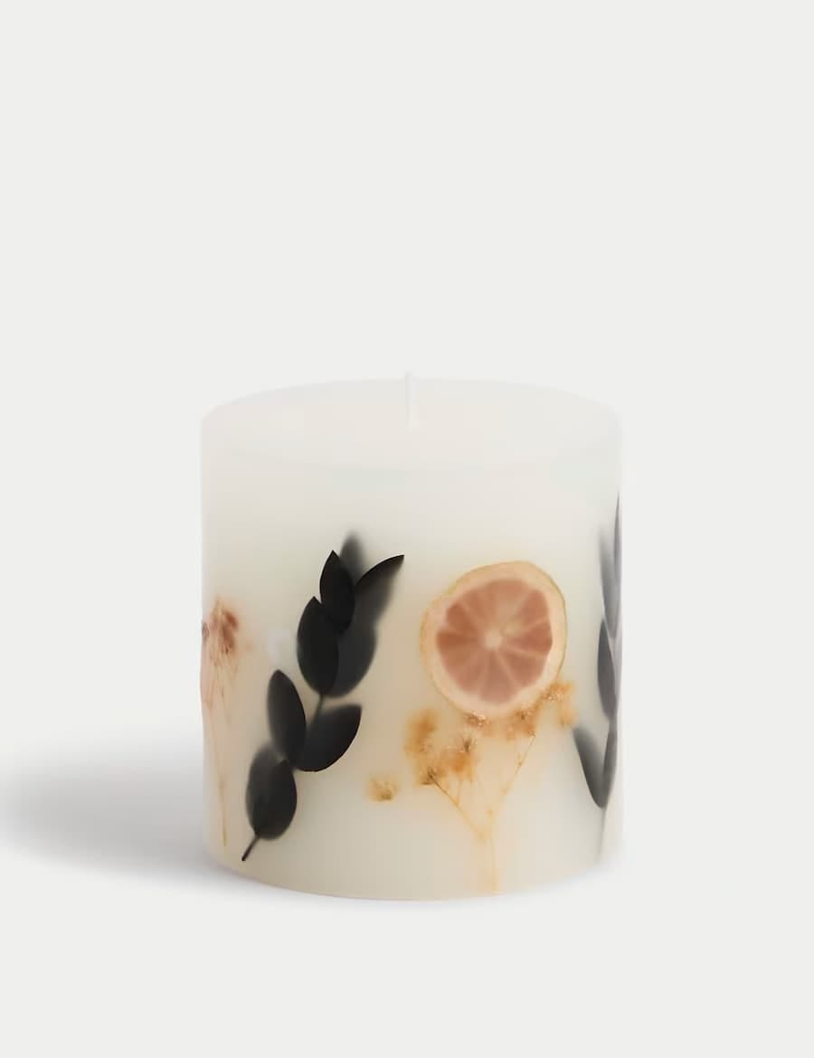 candle with leaves and fruit slices