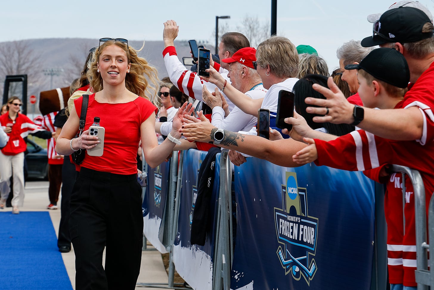 Vivian Jungels in a red shirt, sunglasses, and black pants