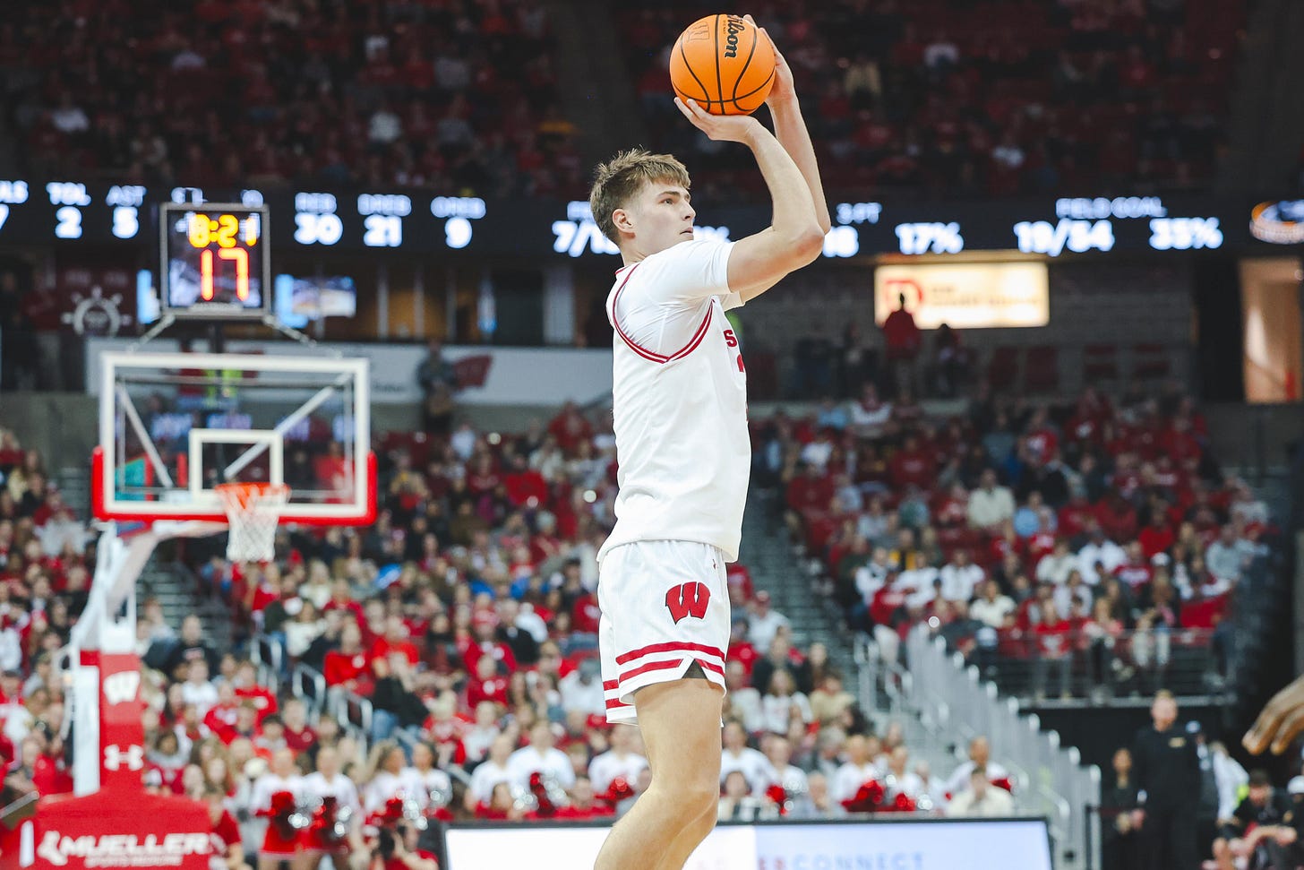 UW basketball forward Nolan Winter prepares to release the basketball while taking a jumpshot inside the Kohl Center