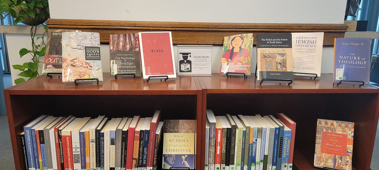 A collection of books on different religions on display in a university library.