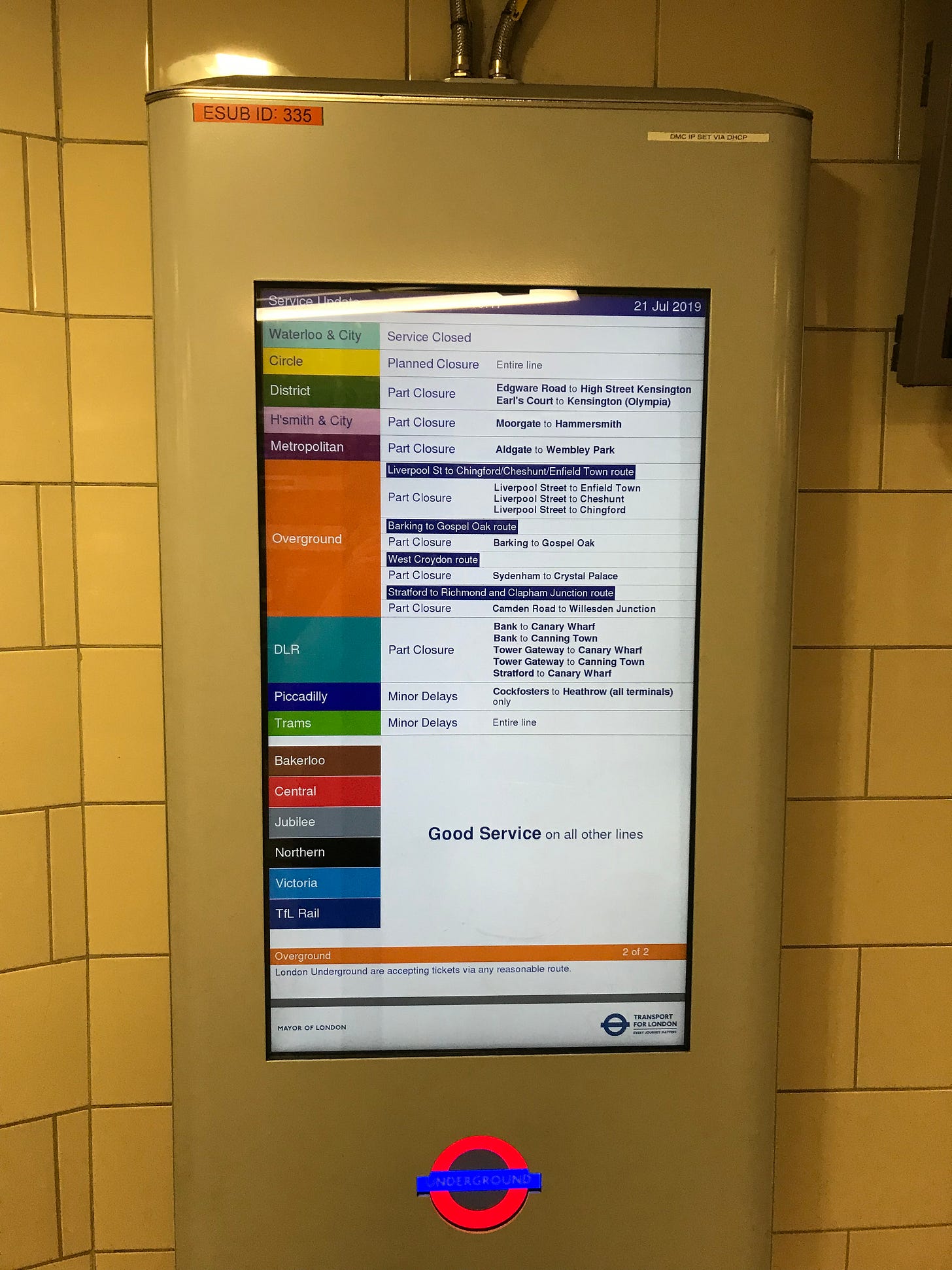 Photo of a TfL rainbow service status screen showing various Overground routes with disruption.