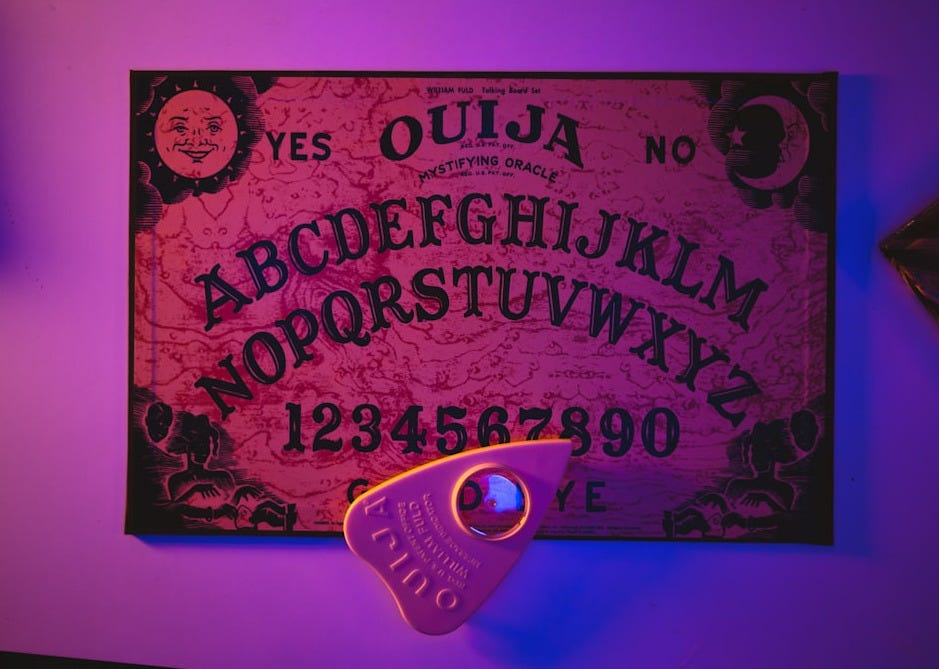 a purple lit room with a sign and a pair of scissors