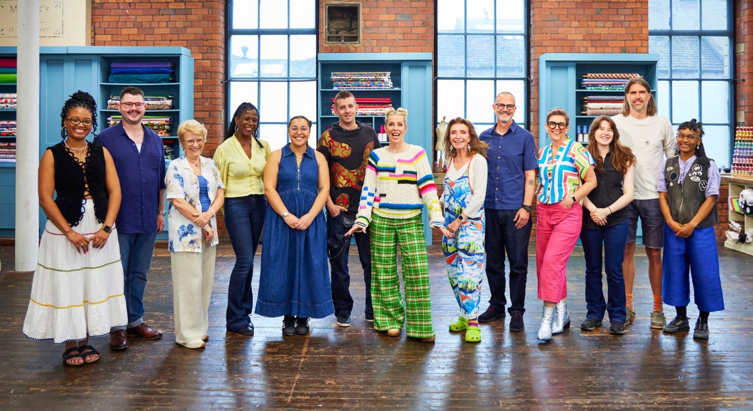 A group of contestants from The Great British Sewing Bee in front of blue bookshelves, brick walls, and tall windows A group of contestants from The Great British Sewing Bee in front of blue bookshelves, brick walls, and tall windows