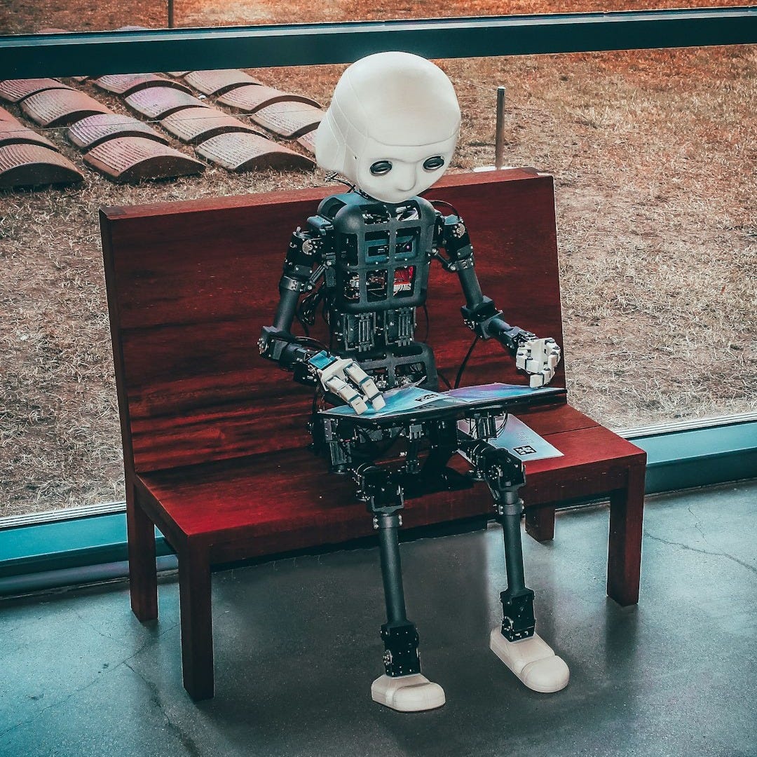 black and white robot toy on red wooden table black and white robot toy on red wooden table