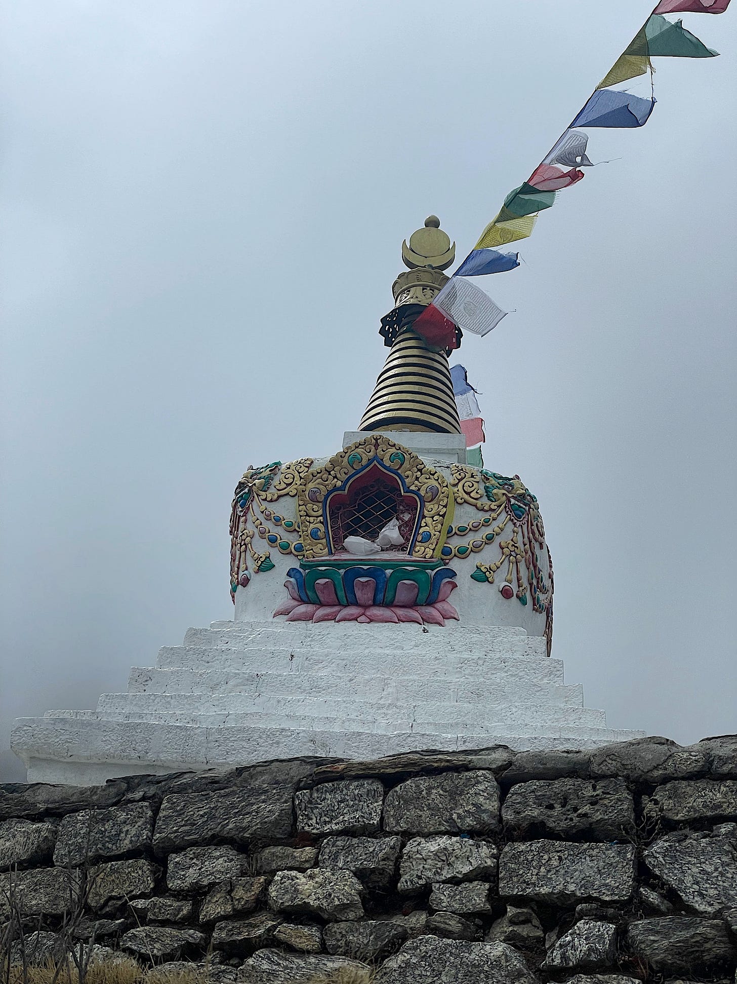 We passed the same stupa as before, this time socked in with clouds.