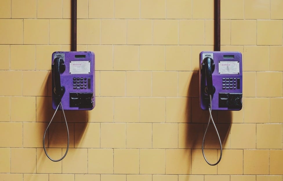 two purple wall telephones