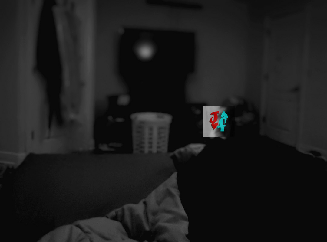 A photo of a bedroom at night, with blankets in the foreground, and an out of focus flatscreen TV in the background. A photo of a bedroom at night, with blankets in the foreground, and an out of focus flatscreen TV in the background.