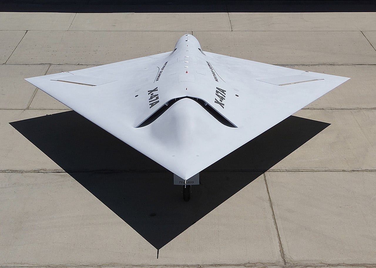 A diamond-shaped drone sits on the ground.