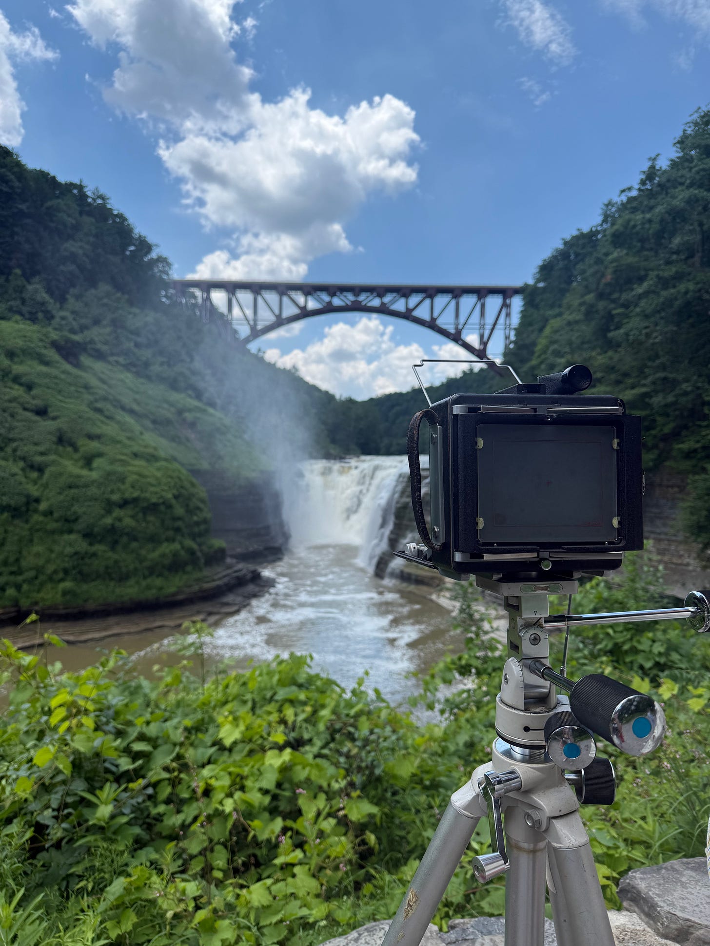 4x5 large format camera in front of a waterfall and bridge at Letchworth State Park, NY