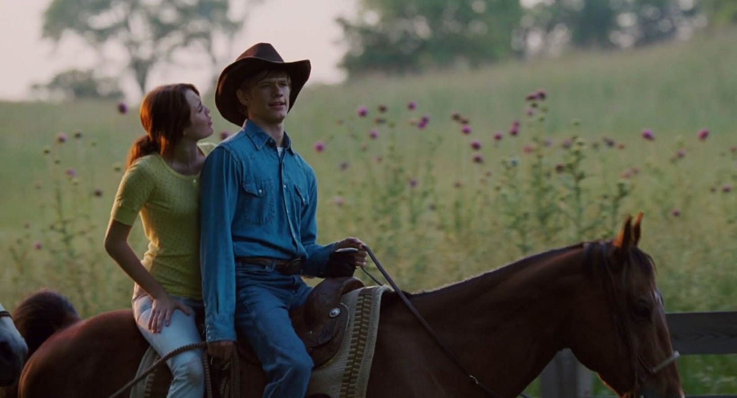 Miley Cyrus and Lucas Till riding horses as Miley Stewart and Travis Brody in Hannah Montana: The Movie.