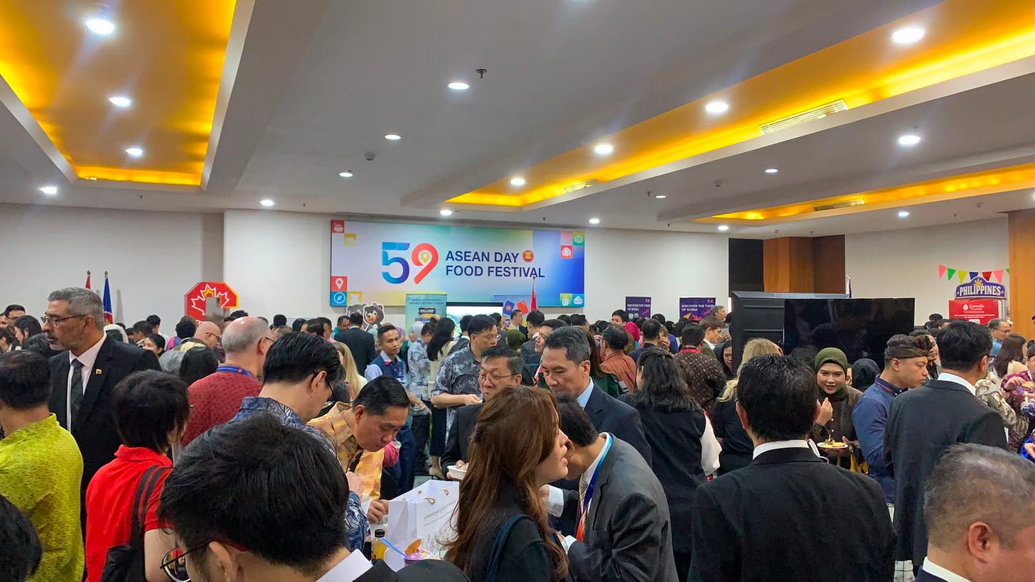 A display of Southeast Asian and international food stalls at the ASEAN Food Festival in Jakarta, with visitors exploring the event.