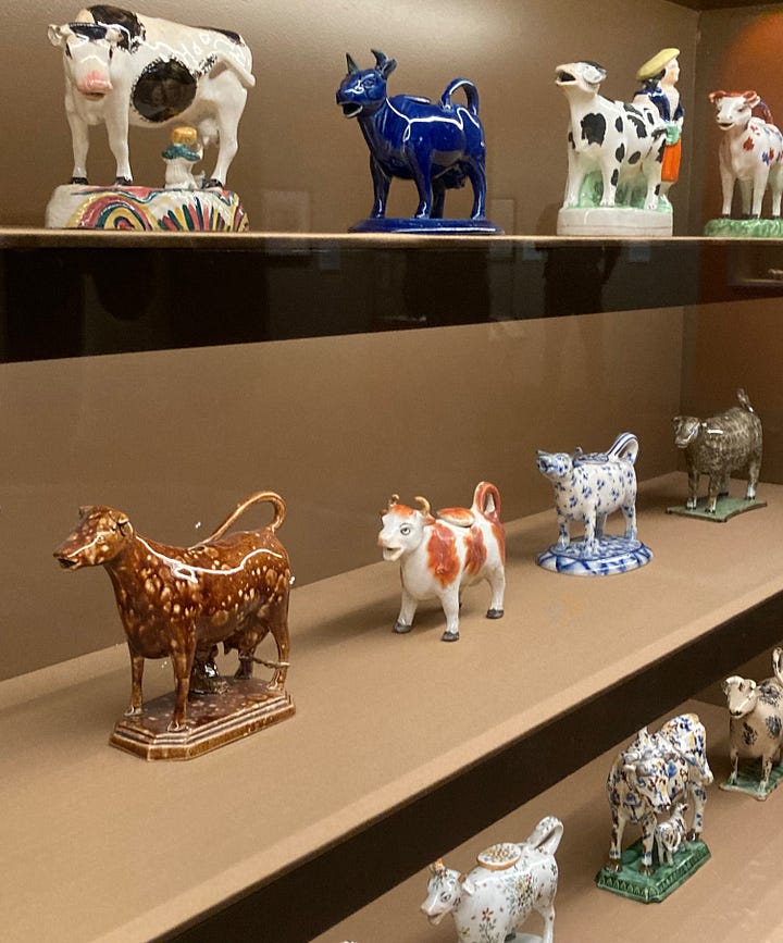 Four images of ceramic cow creamers, made late 18th centruy to early 19th century, and image of shelves holding several jugs