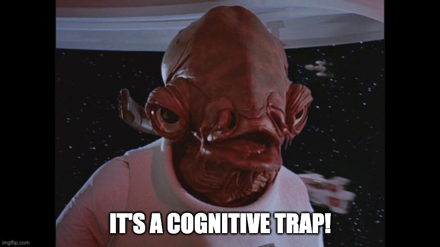 Admiral Ackbar from Star Wars appears mid-sentence on a spaceship, with the caption “IT’S A COGNITIVE TRAP!”—a parody of his famous line “It’s a trap!” used here to humorously highlight flawed thinking or decision-making patterns.