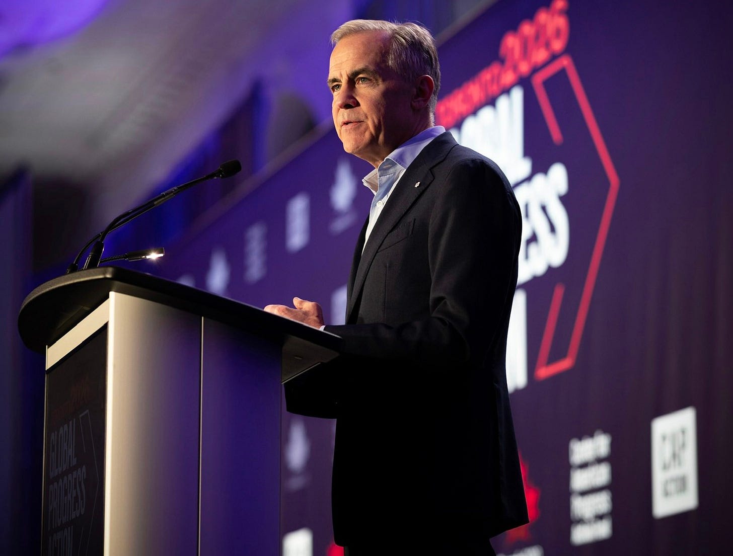 Prime Minister Carney talks at a podium in Toronto, Ontario.